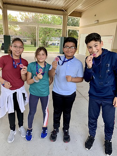 Fifth-grader Zoe Garcia, fourth-grader Ashley Guzman and fifth-graders Anthony Aguilar and Daniel Padilla earned their medals for running 26.2 miles in February.