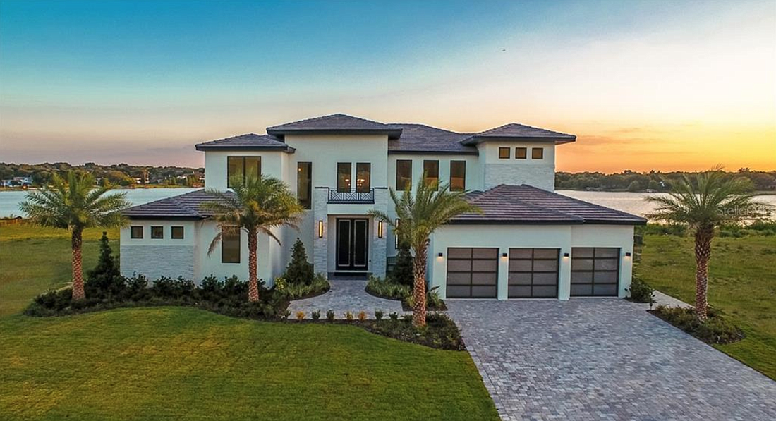 The home at 1336 Lake Olivia Lane, Windermere, 34786, sold March 20, for $1,825,000. It features panoramic lake front views, a custom pool, an outdoor kitchen and multiple entertaining spaces.