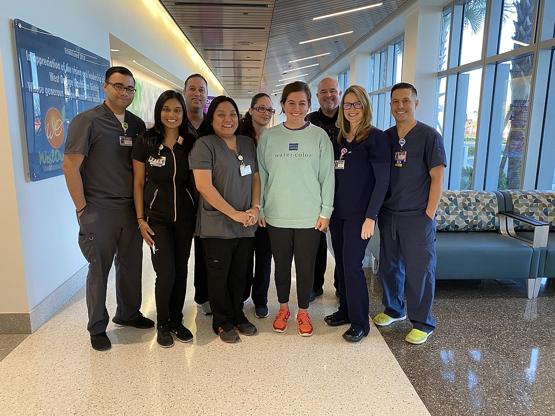 Jessica Sexton, fourth from right, was the 10,000th patient to be treated at the Orlando Health Horizon West Emergency Room. The 31-year-old Windermere resident visited Feb. 20 for undisclosed medical treatment. With her is the emergency room team.