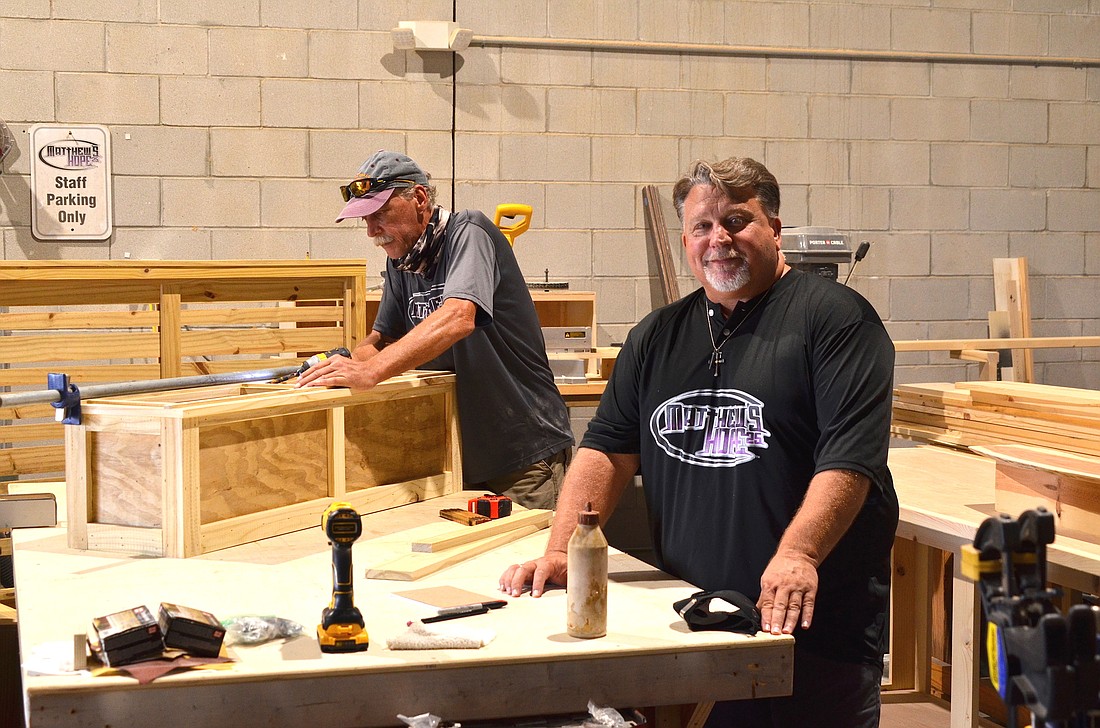 Bruce Przybyla, left, is one of several Matthewâ€™s Hope guests who work in the Hope Chest workshop. Scott Billue is the founder of the homeless ministry.