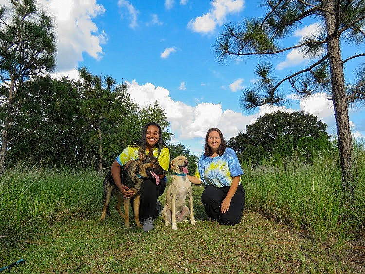 Two of the Bunch-a-Mutts Animal Rescue founders â€” Sharlene Sledge, left, and Rita Lopes â€” are all smiles with their dogs, Royce and Blue.