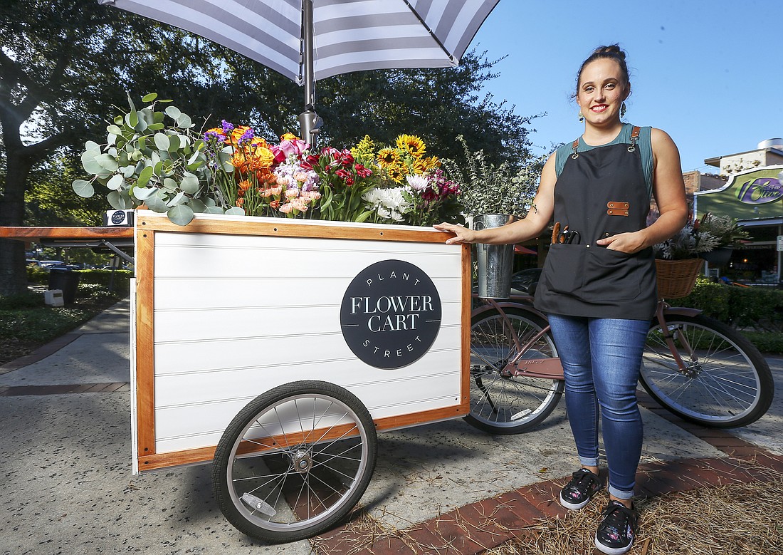 Tasha Harrison sells flowers individually or in bunches from her bicycle-powered flower cart.