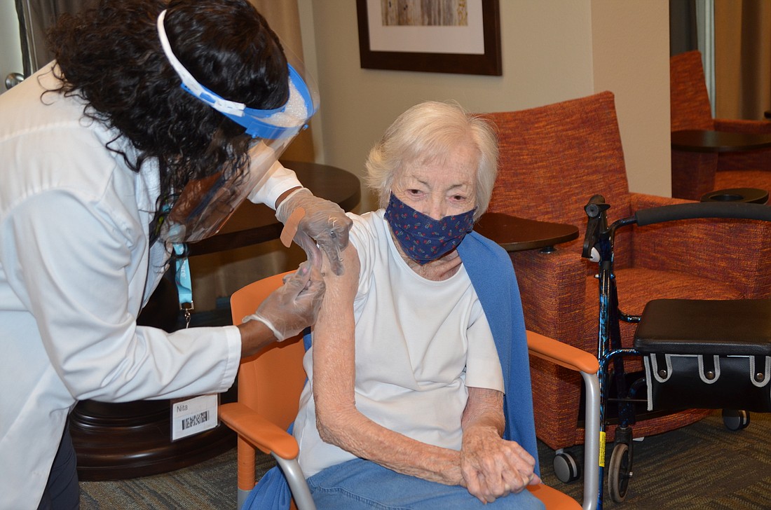 Pharmacist Anita Shaw administered the COVID-19 vaccine to Betty Babitzke, a resident at Sonata West in Winter Garden.