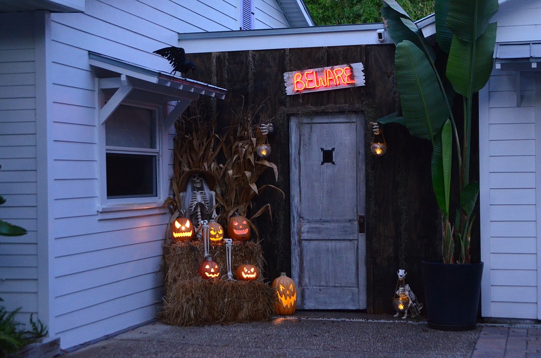 Kevin and Lu Milliken have created a haunted house on the other side of this makeshift speakeasy door.