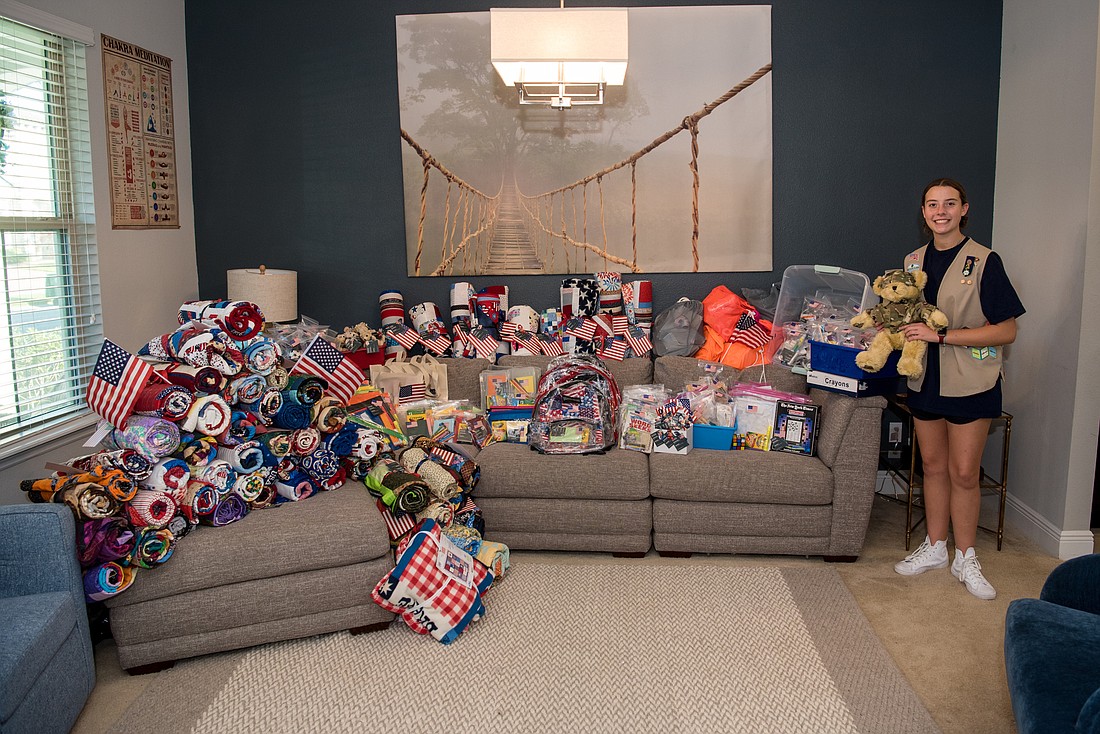 Emily Matlach collected 60 quilts and an assortment of patriotic items and activity kits for veterans at the Orlando VA Medical Center in Lake Nona. Photo courtesy Cricket&#39;s Photo & Cinema