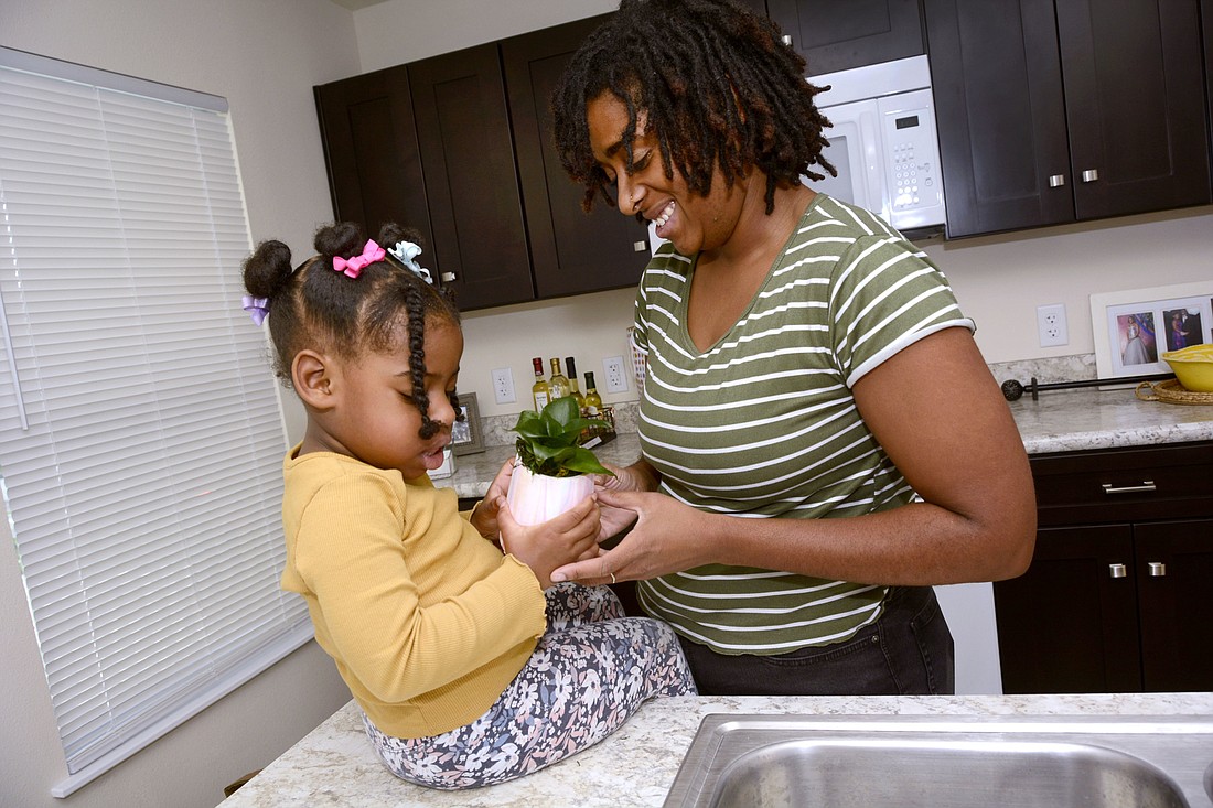 Natalie Kinscy and her daughter, Amiyah, share some quality time in their new Habitat for Humanity home.