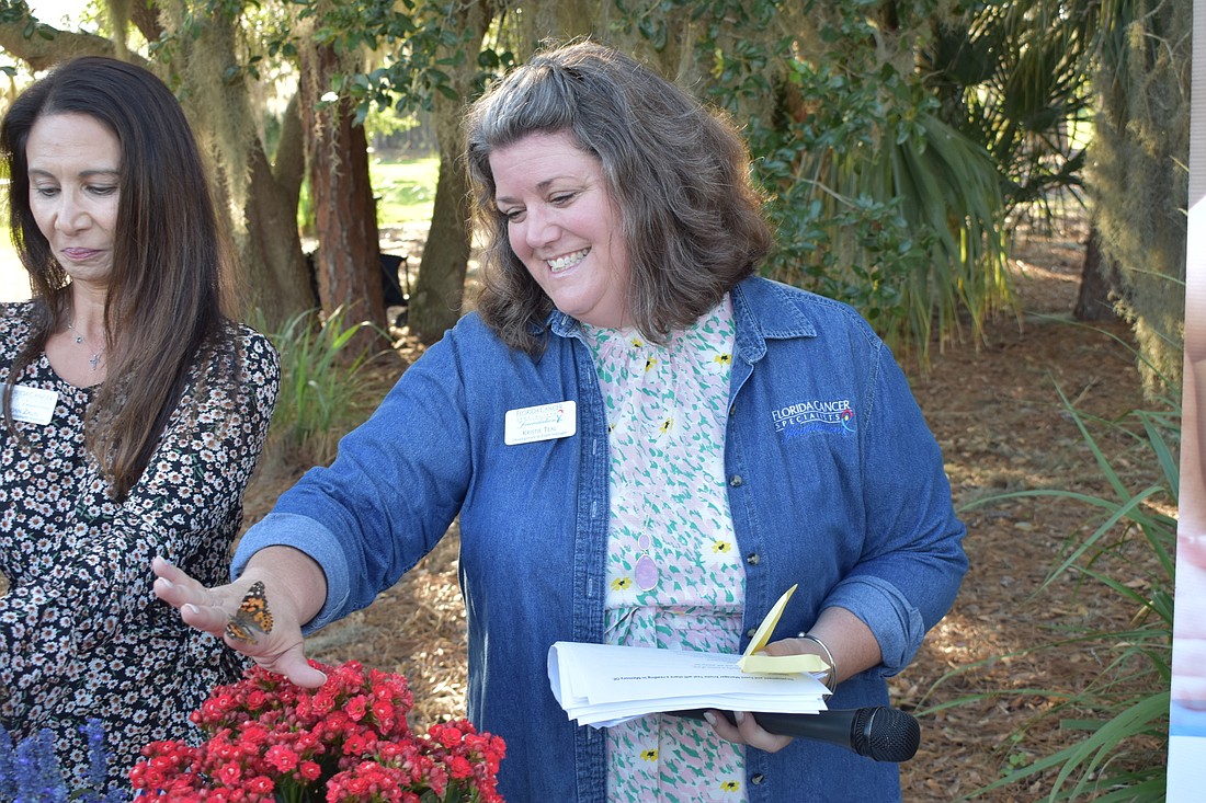 Kristie Teal, development and event manager for Florida Cancer Specialists Foundation, checks out a butterfly as it escapes.