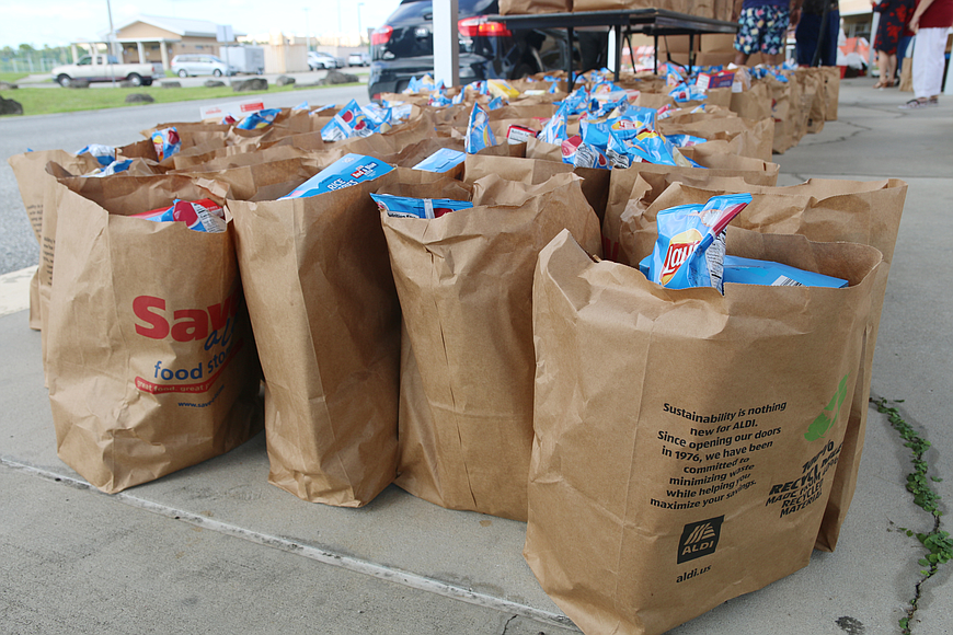 Bags of food stand ready during Food Brings Hope's back-to-school food drive in August 2021. Photo by Jarleene Almenas