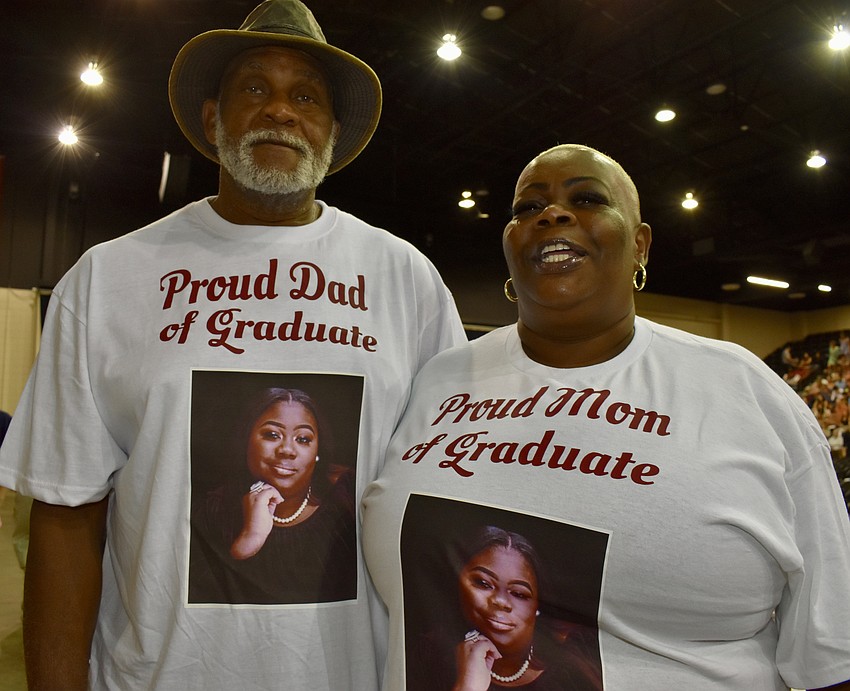 Gregory Crenshaw and Sharon Jackson honor their daughter, Ja'Nylaa Crenshaw, with their graduation day T-shirts.