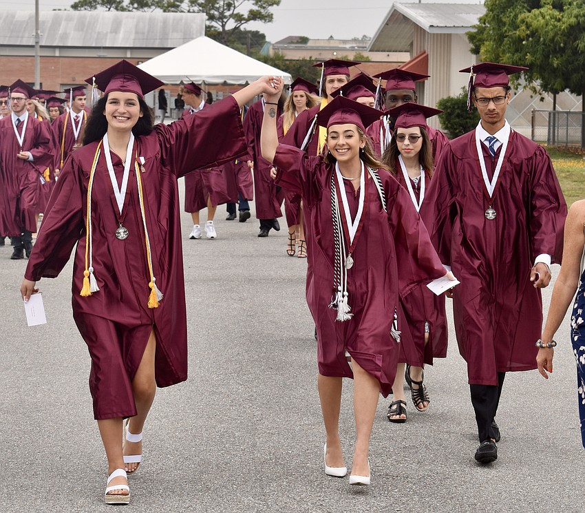 Kayden Mangel and Jaydis Marquez walk with their class toward the entrance of Robarts Arena.