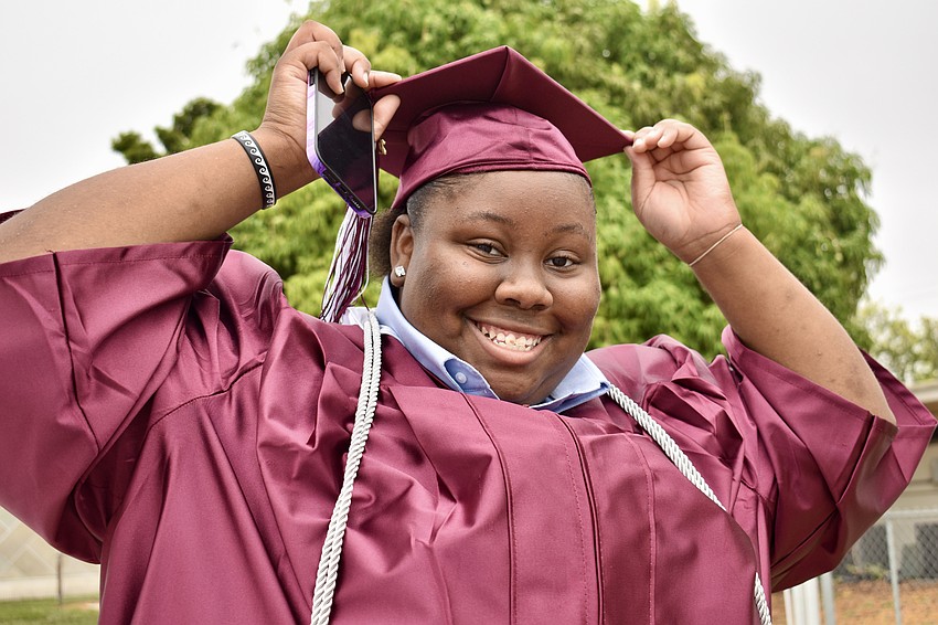 Ja'Nylaa Crenshaw gets her cap adjusted just so.