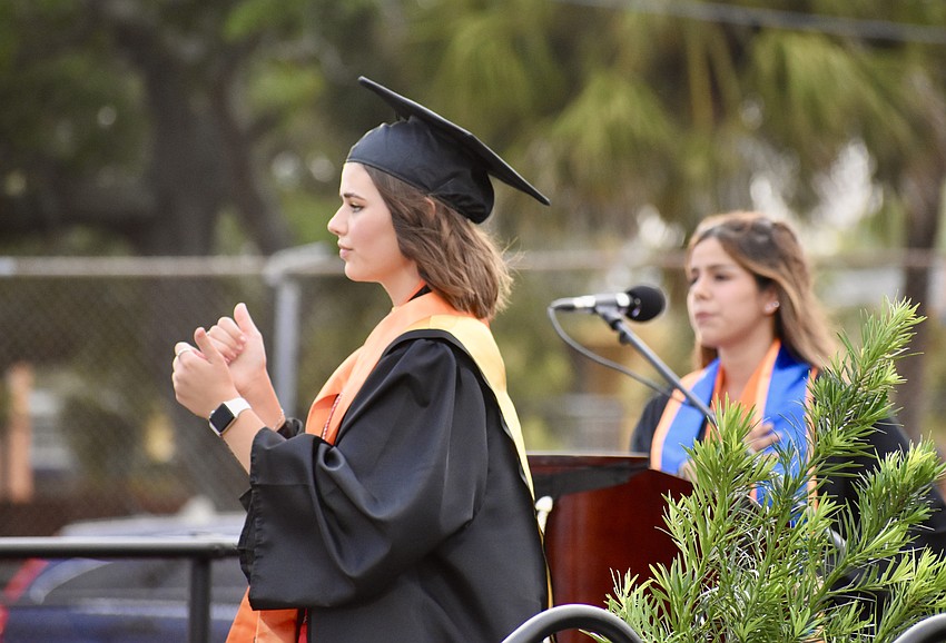 Anya Studebaker signs the Pledge of Allegiance, as recited by Krystal Porlles.