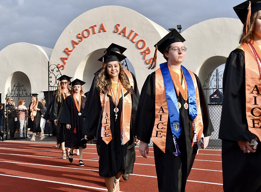 Two lines of seniors file their way into Cleland Stadium.