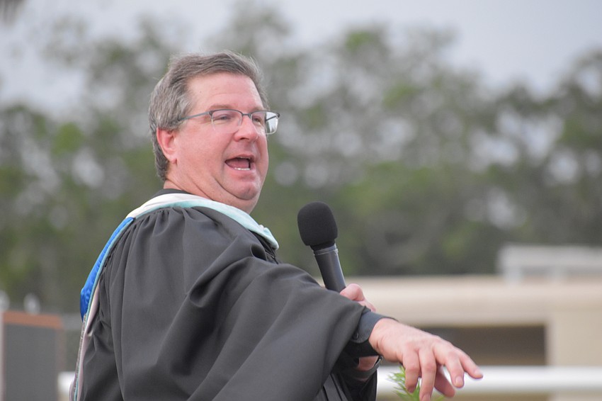Principal David Jones announces students will receive their diplomas before the remainder of the program.