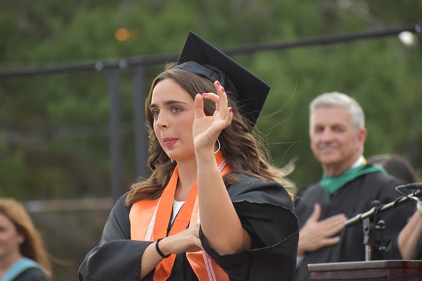 Delaney Hampton signs the Pledge of Allegiance.