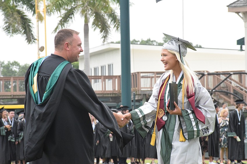 Principal Dustin Dahlquist congratulates Booke Pater.