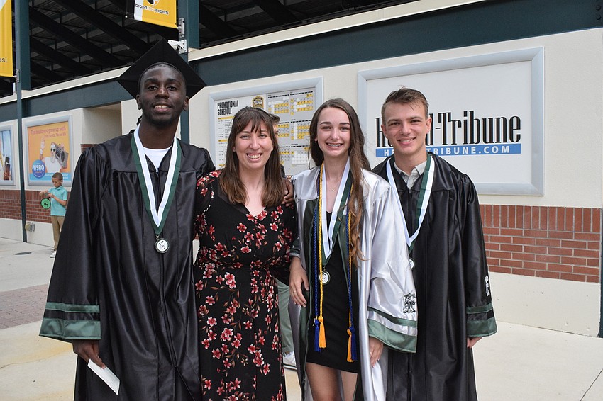 Anatomy and physiology teacher Kelly Smith-Williams (second from left) is proud to see her students Mike Mergina, Isabelle Sorensen and Joseph Puco graduate. 