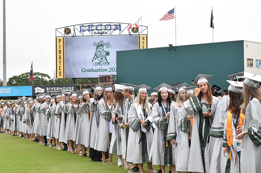 Seniors line up to prepare to walk for graduation.