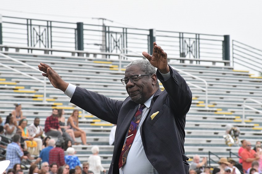 Rev. James Golden, who is a member of the School Board of Manatee County, waves to  the crowd.