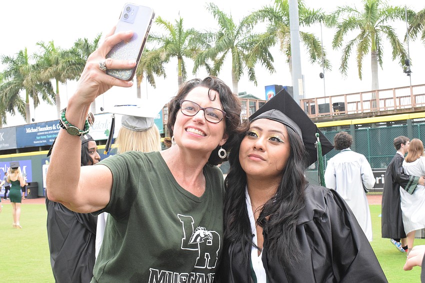 Terri McAllister, who is retiring after 21 years in education, takes a selfie with her student and graduate Yadira Morales.