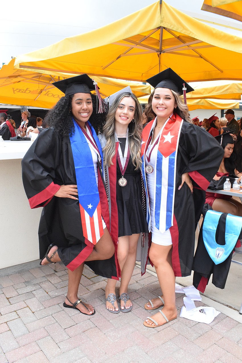 Taily Williams, Tuleen Jibril and Jolee Tison wear stoles and cords representing their heritages and accomplishments.
