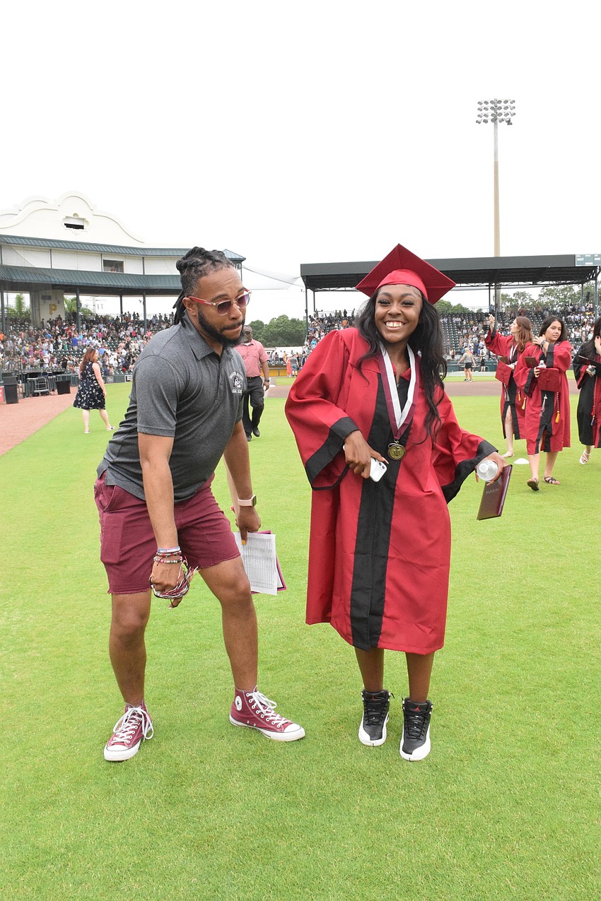 Ricardo Robinson-Shinall, a Braden River High School teacher, dances with Alani Arrington-Bey to the graduation version of 