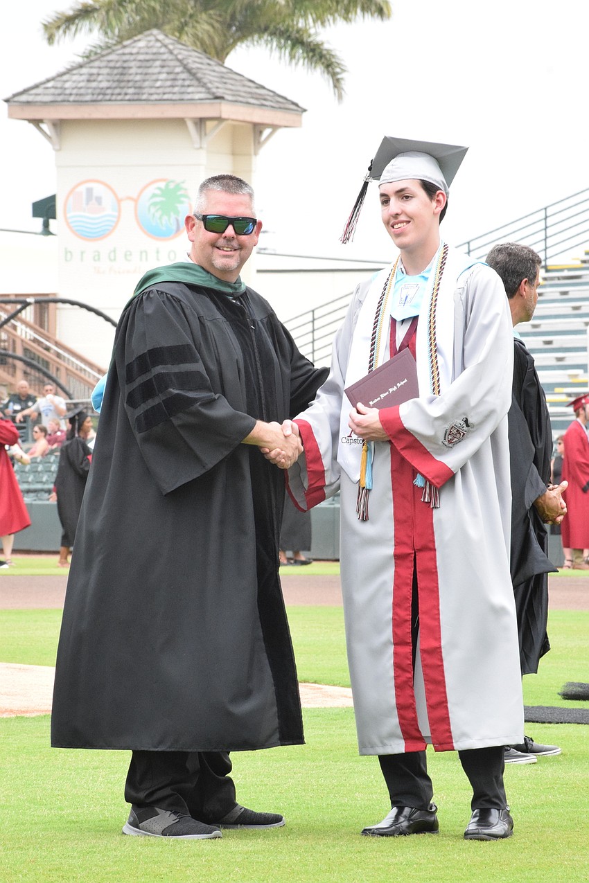 Principal Carl Auckerman congratulates Liam Wilford.