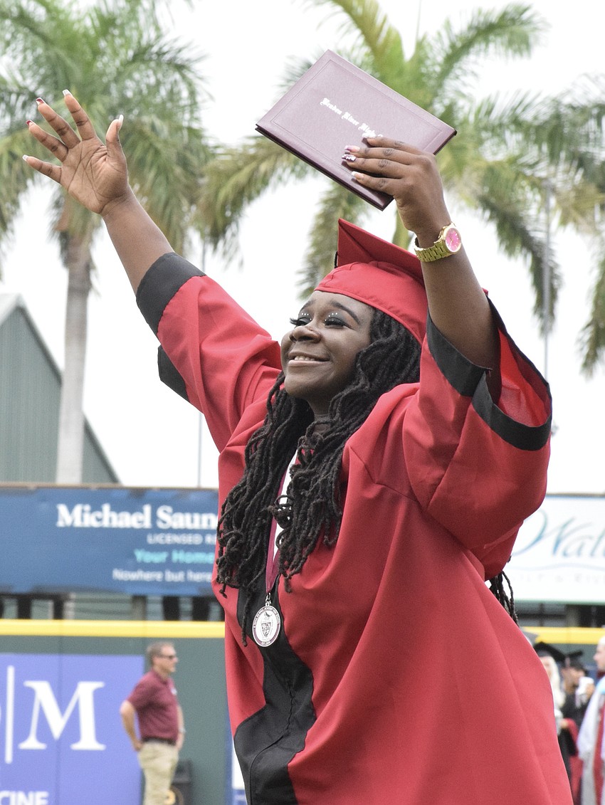 Rheyana Hamilton releases her emotion as she celebrates her graduation at LECOM Park.