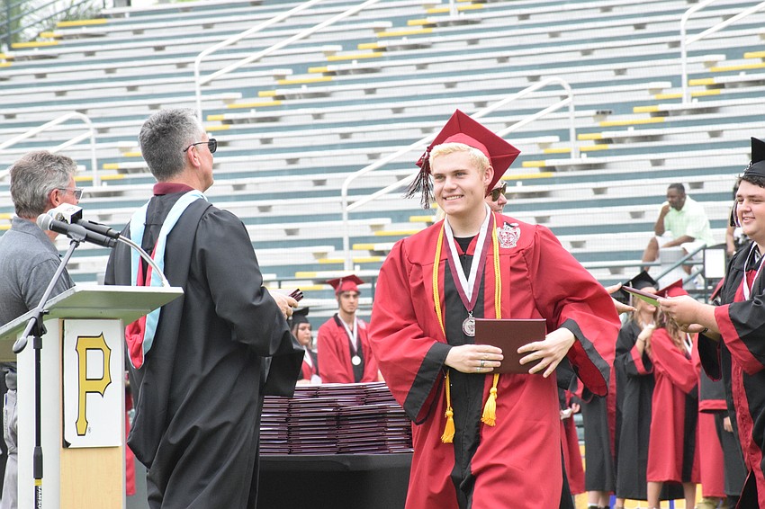 Tyson Dueer smiles as he makes he way across the field with his diploma in hand.