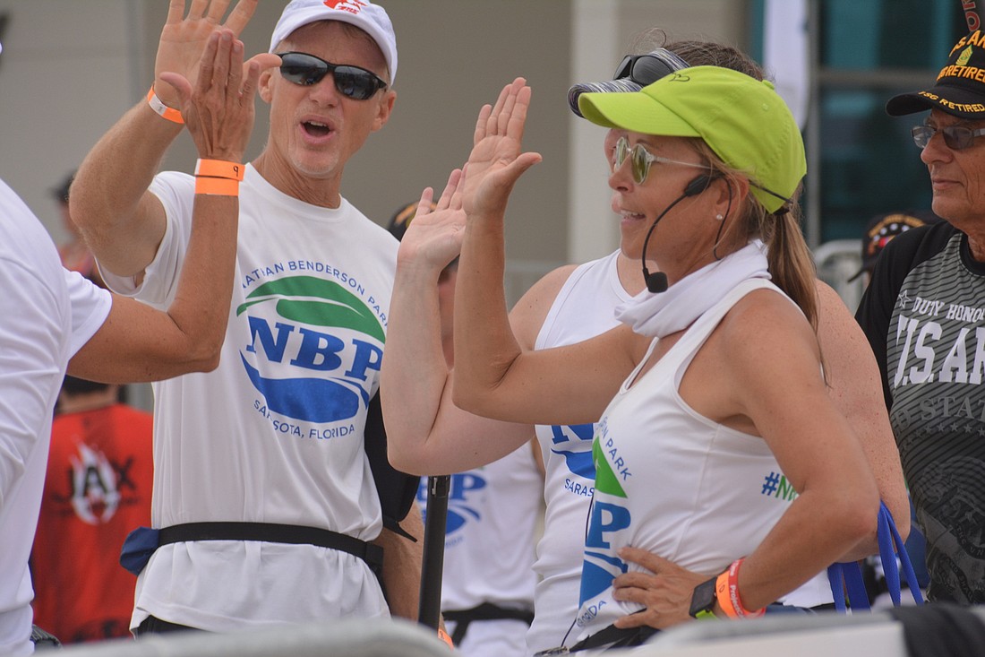 Angela Long gives high fives to her NBP Dragons paddlers after getting off the water during the 2022 Sarasota International Dragon Boat Festival. Long was named the head paddling coach at Nathan Benderson Park in 2021.