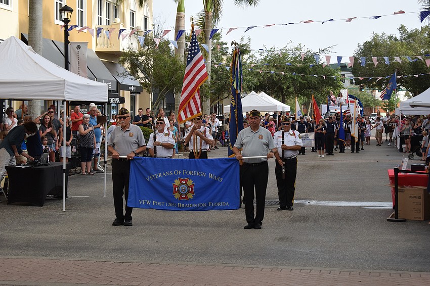 Gill Ruderman and Herman Martinez carry the banner for VFW Braden River Post 12055.