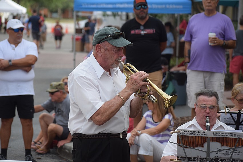 Lakewood Ranch Wind Ensemble Conductor Joe Miller joins the group on trumpet on Lakewood Main Street.