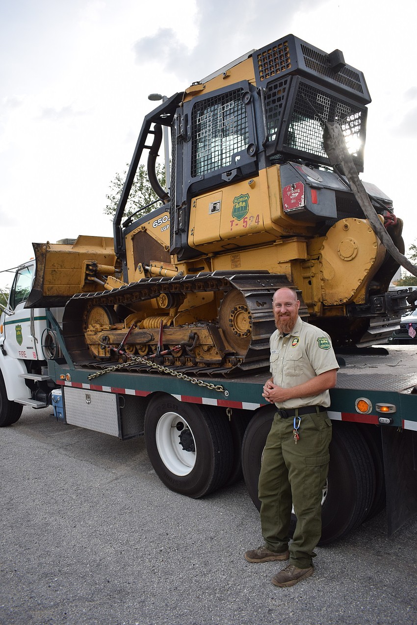 Logan Hatch of the Florida Forest Service says he washed the dozer just for the parade, Unfortunately, it was too high for the streamers and had to sit it out. It has, however, helped to stamp out 10 fires since January.
