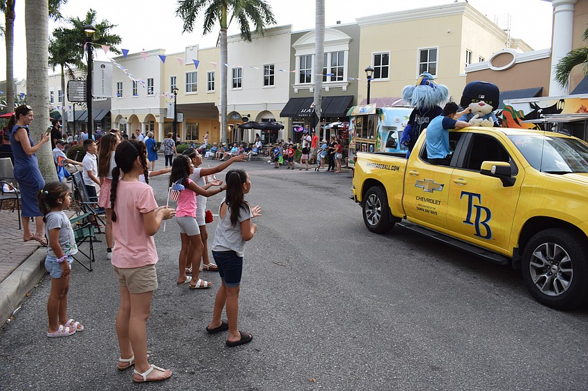 Besides enjoying the mascots, children received some candy and flags as well as vehicles passed.