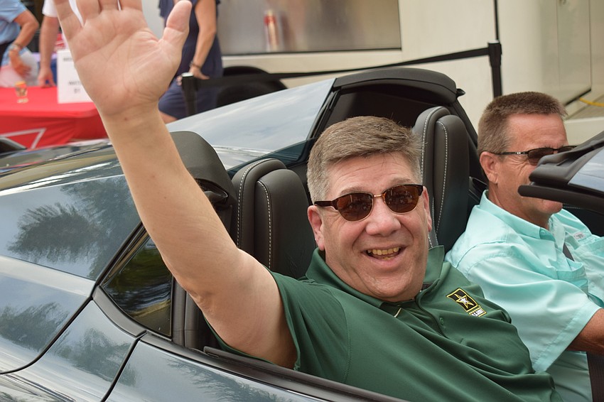 Retired U.S. Army solder Eric Onstad of Lakewood Ranch enjoys an honorary ride in a Corvette during the Tribute to Heroes Parade.