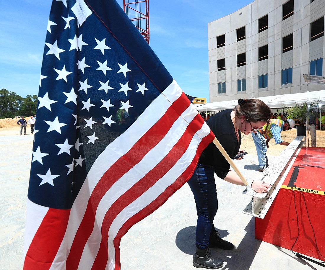 Members of the AdventHealth and construction teams signed their names on the beam before it was raised atop the 4-story structure. Courtesy photo
