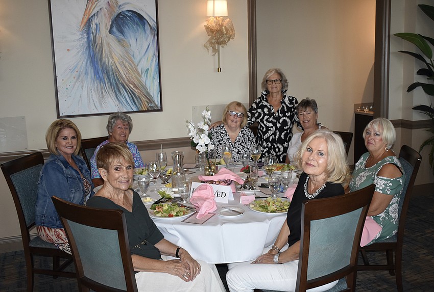 Models Patricia Harper, Nancy Morgans (top), Anastasia Tess Magoulas (bottom), Christine Nichols-Brown, coordinator Eloise Eckler, and models Ellen Hunt, Joan Clowser, and Kathleen Link, gather together during dinner.