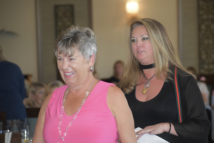 Ellen Hunt walks down the runway while Jodi Frauhiger tells the crowd about her outfit.