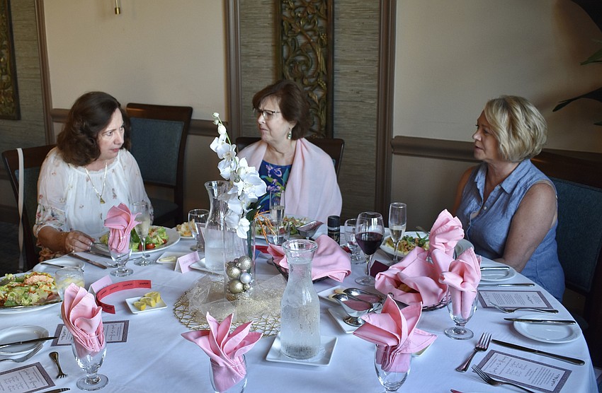 Gordana Picinich, Mary Ward, and Deon Gould, residents of River Strand, await the start of the show that benefitted the Manatee County Food Bank.