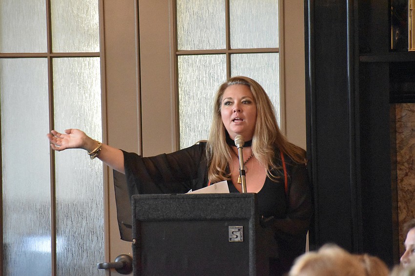 Jodi Frauhiger, general manager of Foxy Lady, introduces the models.