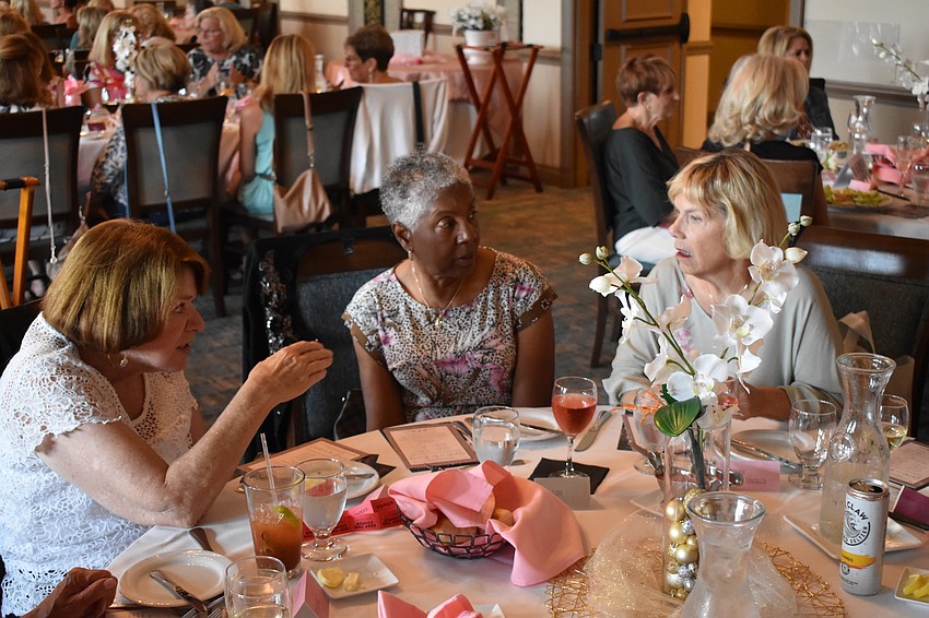 Vivienne Sivak, Nedra Clark, and Marlene Manela-Sincaglia socialize over dinner and some wine.