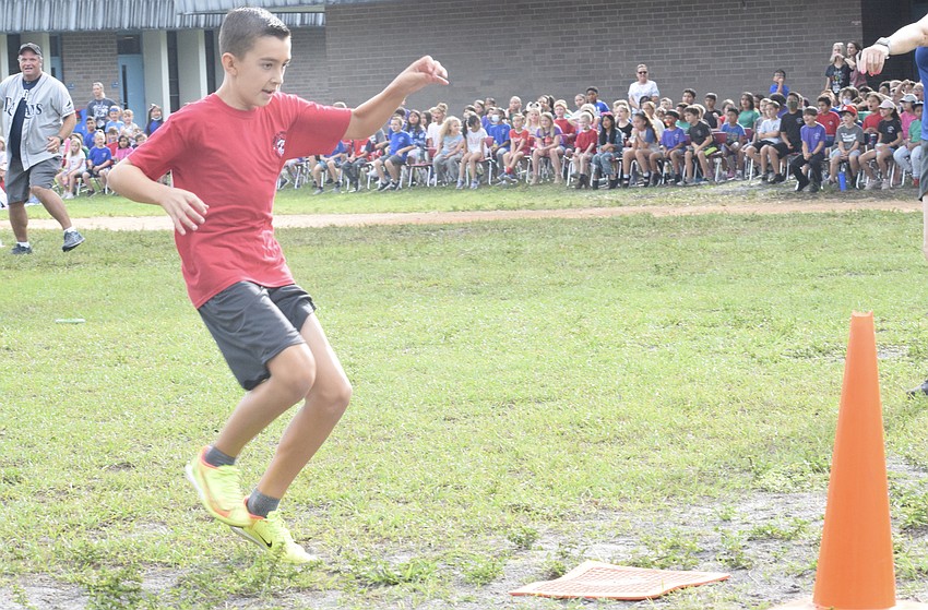 Fifth grader John Castro makes it safely to third. He went on to score a run for the fifth graders in the first inning.