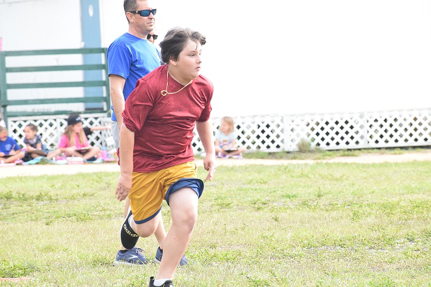 Fifth grader Nick Catterson makes a run for third base.