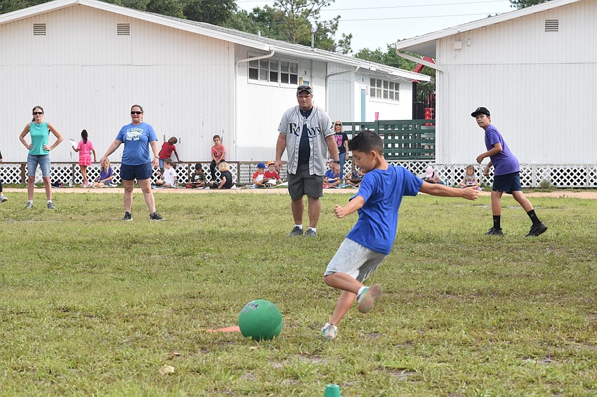 Both staff and fifth graders get competitive in the staff versus fifth grade kickball game.