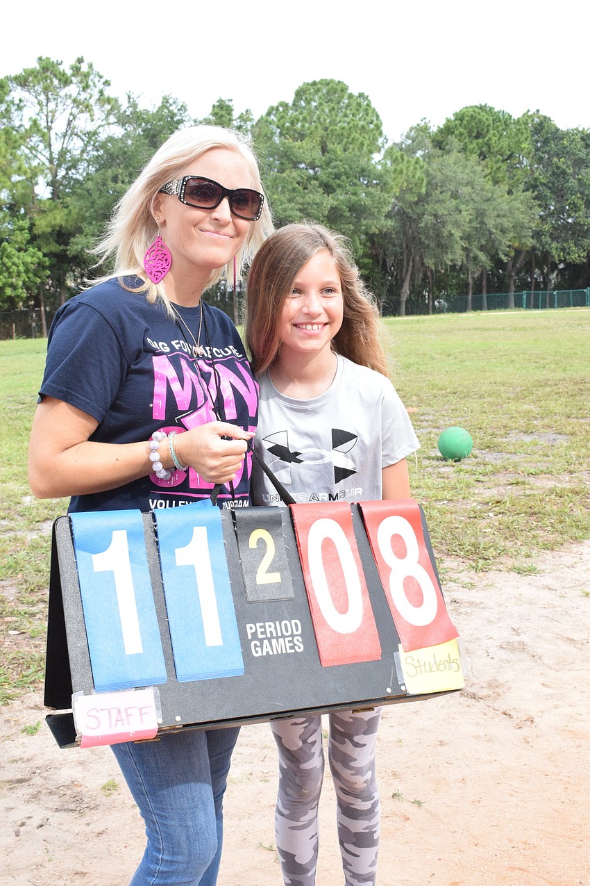First grade teacher Melissa Hagood supports her daughter Logan Hagood, who is in fifth grade, as she plays in the staff versus fifth grade kickball game.