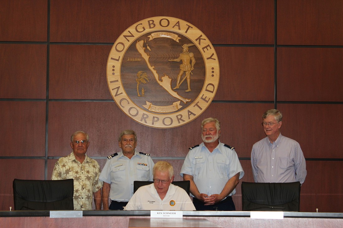 Mayor Ken Schneier proclaims May 21-27, 2022 as National Safe Boating Week. Behind him from left to right are rear admiral Bill Merlin, flotilla commander James Barnard, flotilla officer Zac Tapp, and rear admiral Steve Branham.