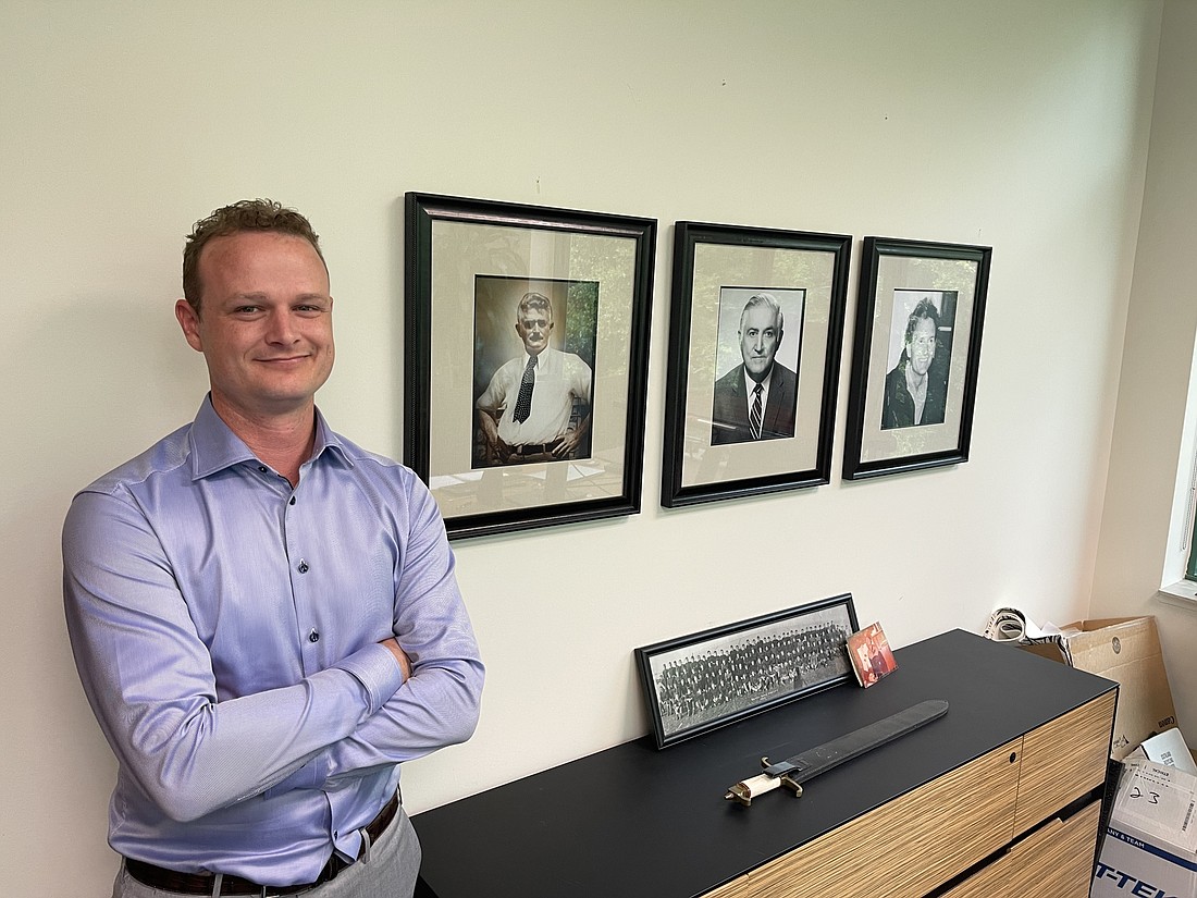 Superior Construction owner Nick Largura has portraits of his great-grandfather, grandfather and father in his office. From left, great-grandfather, Giovani Largura; grandfather Elio Largura and father, Thomas Largura.