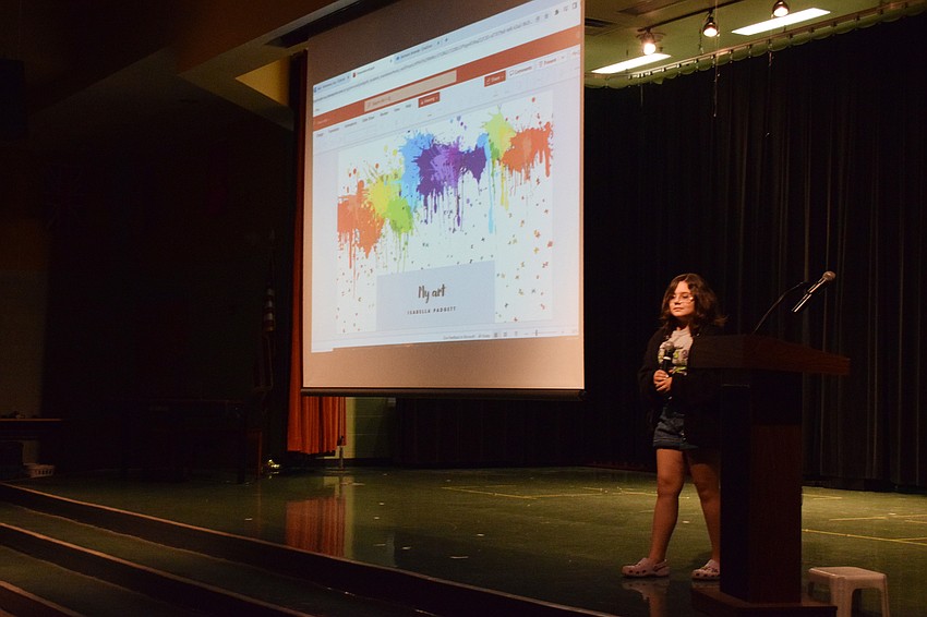 Fifth grader Isabella Padgett shares her artwork in a slideshow while explaining the different forms of art she works on and her style.