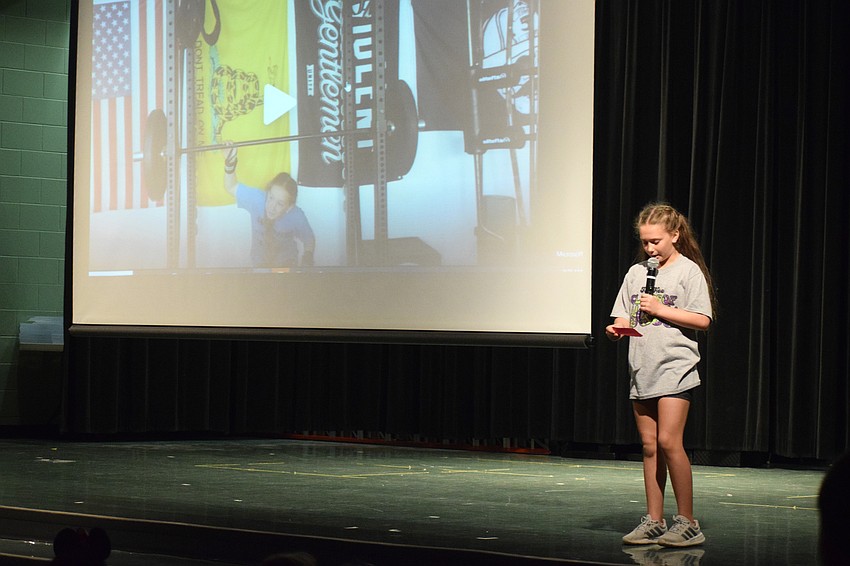 Fifth grader Lily Bertrand's talent is strength, so she shows a video of her doing a squat with weights.