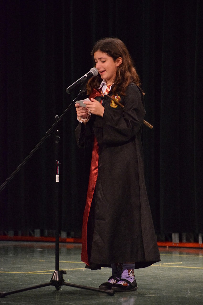 Fifth grader Ava Arroyo encourages students to read the 